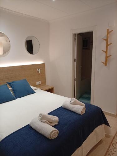 a bedroom with a bed with towels on it at Hotel Iberflat Marynton in Benicarló