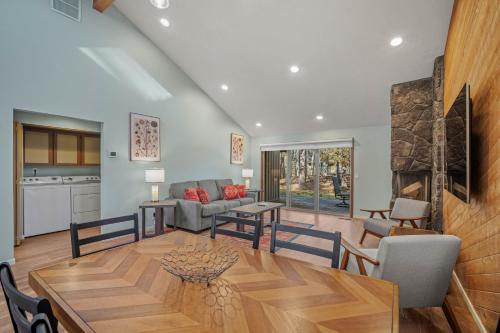 a living room with a table and a kitchen at 4 Quelah Condo in Sunriver