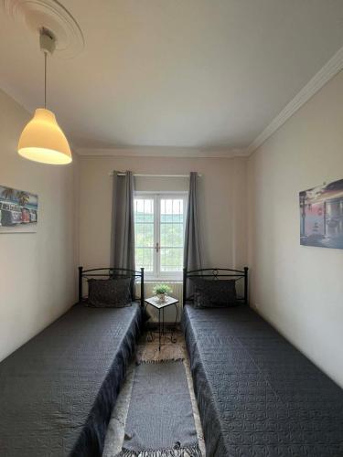 a living room with two beds and a window at V&M Residence Upper Level in Mesagrós