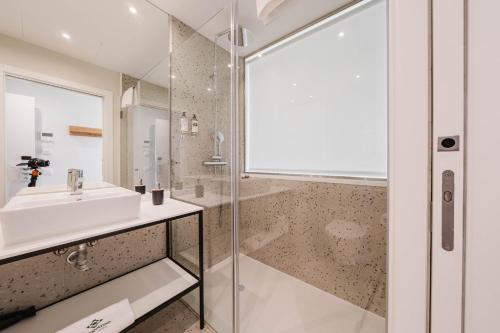 a bathroom with a sink and a shower at Liberator Rossio in Lisbon