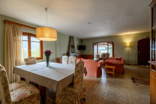 a dining room with a table and a living room at Ioanna Sunset Retreat in Chalkida