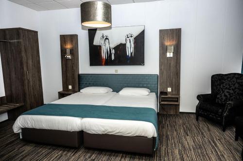เตียงในห้องที่ Hotel Hof van Twente