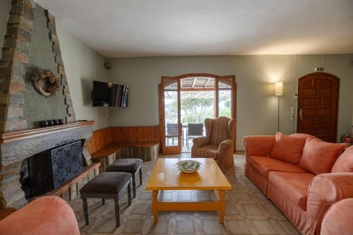 a living room with a couch and a fireplace at Ioanna Sunset Retreat in Chalkida