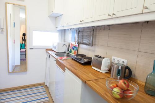 a kitchen with a counter with a bowl of fruit on it at Self check-in eco studio in the heart of Buda in Budapest