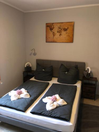 a bedroom with two beds with towels on them at Pension Karsten Mertens in Gardelegen