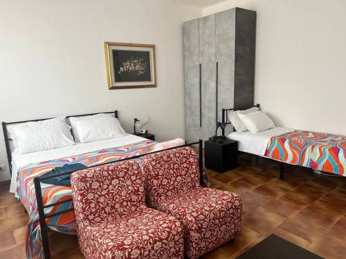 a bedroom with a couch and a bed and a chair at Wellness in Malpensa - (check in entro le 22) in Samarate