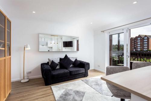 a living room with a couch and a table at Harbour House - Donnini Apartments in Ayr