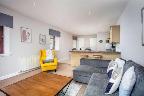 a living room with a couch and a yellow chair at Elliot Suite No2 - Donnini Apartments in Ayr