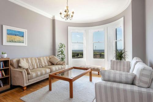 a living room with two couches and a coffee table at Sea Breeze - Donnini Apartments in Ayr