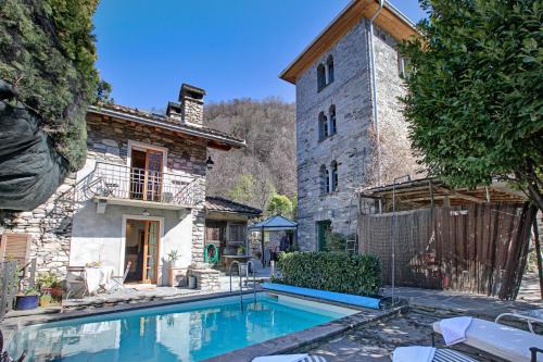 a large swimming pool in front of a building at Mille Colline la Casa 1 with Shared Pool - Happy Rentals in Pianezzo