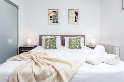 a bedroom with a bed with white sheets and pillows at Elliot Suite No 1 - Donnini Apartments in Ayr