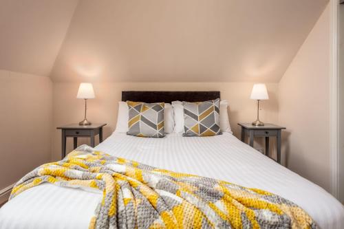 a bedroom with a large bed with two lamps at Elliot Suite No9 - Donnini Apartments in Ayr