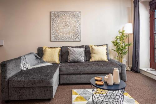 a living room with a couch and a table at Elliot Suite No9 - Donnini Apartments in Ayr