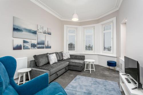a living room with a couch and a tv at Seaforth Suite - Donnini Apartments in Ayr