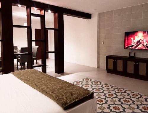 a bedroom with a bed and a flat screen tv at Casa San Martín, Campeche #1 in Campeche
