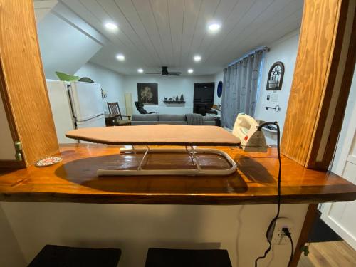 a kitchen counter with a cutting board on top of it at Our Place Up North BnB in Huntsville