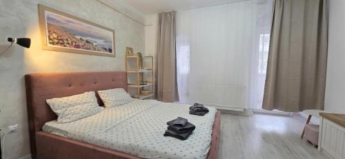 a bedroom with a bed with hats on it at Single room Perfect for couples or singles in Roşu