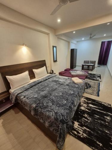 a bedroom with a large bed in a room at Little Tibet Mcleodganj in Dharmsāla