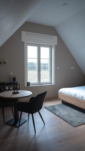 a bedroom with a bed and a table and a chair at Maison Malo in As