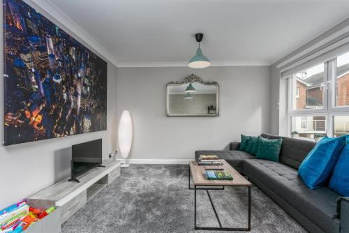 a living room with a couch and a tv at Iona Residence - Donnini Apartments in Ayr