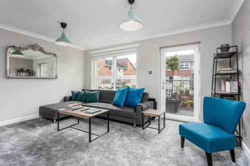 a living room with a couch and a table at Iona Residence - Donnini Apartments in Ayr