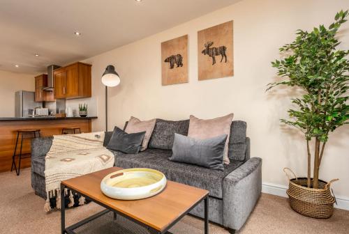 a living room with a couch and a table at Elliot Suite No7 - Donnini Apartments in Ayr