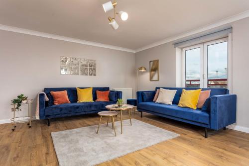 a living room with two blue couches and a table at Waverley Suite No57 - Donnini Apartments in Ayr