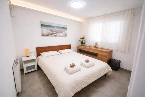 a bedroom with a large white bed and a window at VIP private Poolsuite Calafell in Calafell
