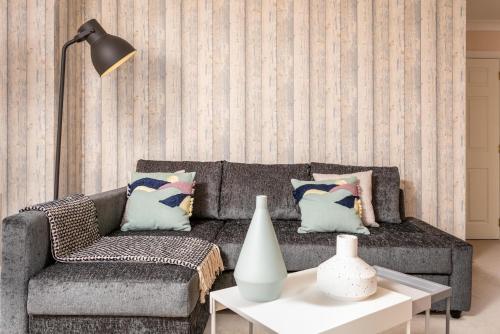 a living room with a couch and a table at The Lucas - Donnini Apartments in Ayr