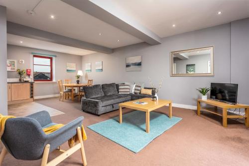 a living room with a couch and a table at Elliot Suite No15 - Donnini Apartments in Ayr