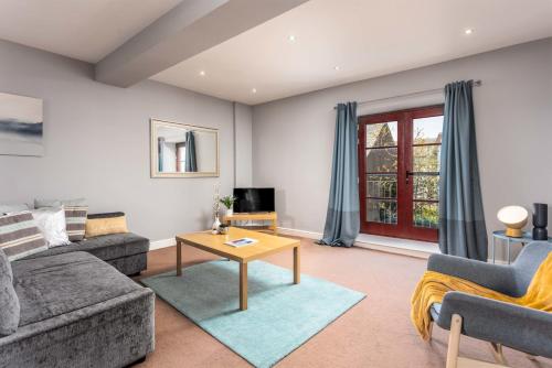 a living room with a couch and a table at Elliot Suite No15 - Donnini Apartments in Ayr