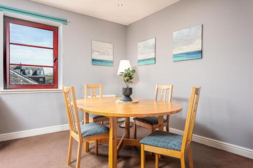 a dining room with a wooden table and chairs at Elliot Suite No15 - Donnini Apartments in Ayr