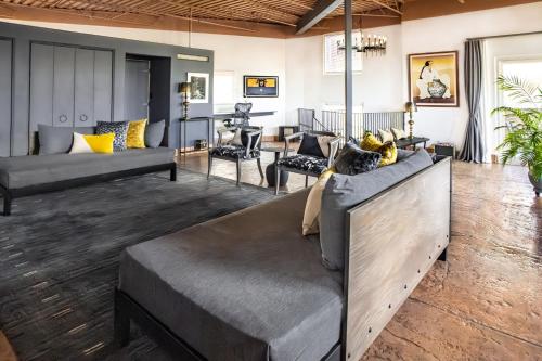 a living room with couches and a table at Heart of Vibrant Railyard-Large Downtown Loft with Prime Location and Beautiful Deck in Santa Fe