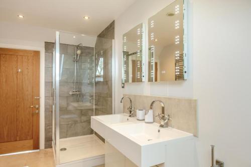 a bathroom with a sink and a shower at 4 Bed in Caernarfon oc-86423 in Pen-y-groes