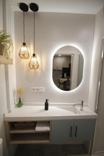 a bathroom with a sink and a mirror at LaJoya De La Villa in Priego de Córdoba