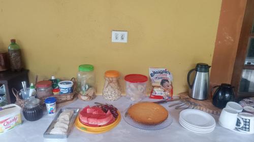 a table with food and other items on it at Chacara desejo do coração dois in Juquitiba