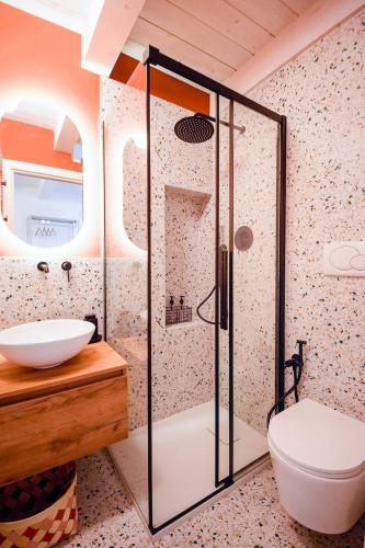 a bathroom with a shower and a toilet and a sink at Boemondo 33 in Bari