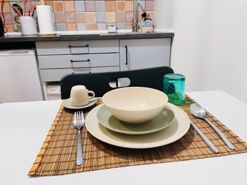 a table with a bowl and a plate on a placemat at Casa das Férias in Lisbon