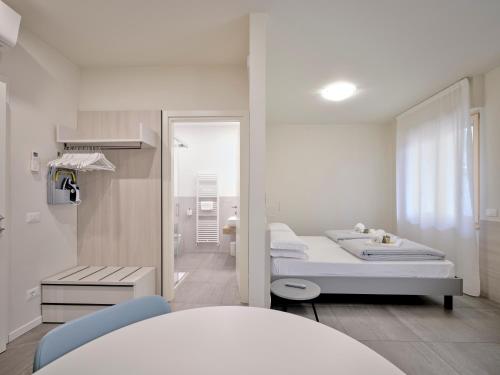 a hospital room with two beds and a mirror at Pegaso Civico2 in Garda