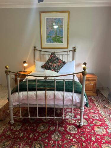 a bed with two pillows on it in a bedroom at Cedara Way Cottage in Hilton