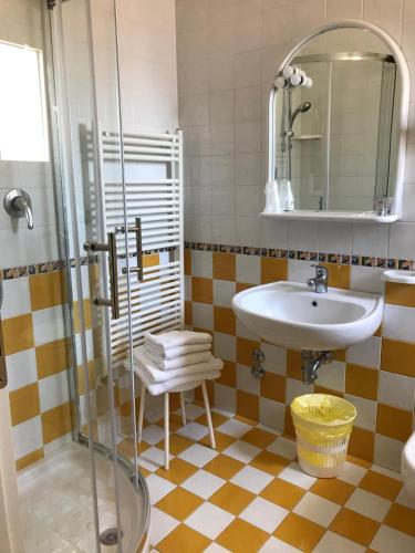 a bathroom with a sink and a shower at Hotel Gardenia in Caorle