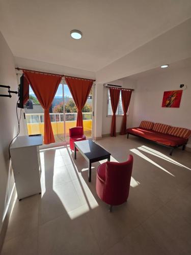a living room with a couch and chairs and a table at Departamento Alberdi in San Pedro de Jujuy