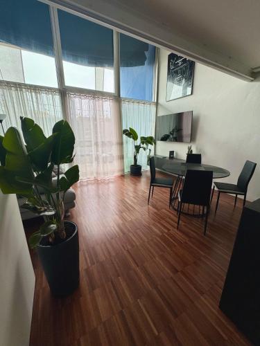 a room with a table and chairs and a dining room at Private Luxury Loft in Crescenzago