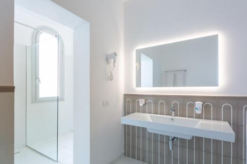 a bathroom with a sink and a mirror at San Francesco Amalfi Coast Hotel in Maiori