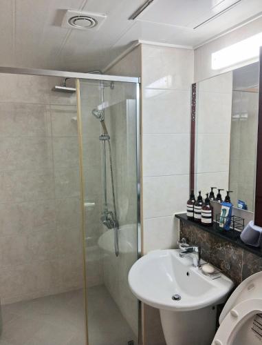 a bathroom with a sink and a shower at 부산남포 프론트오션뷰 in Busan