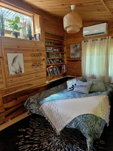 a bedroom with a bed with wooden walls and a window at Domaine d'Avalon in Lorgues