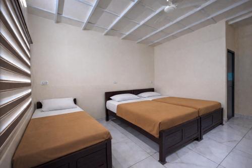 a bedroom with two beds and a window in it at WAYNEST by SHELTERS in Meppādi