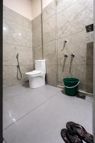 a bathroom with a toilet and a shower at WAYNEST by SHELTERS in Meppādi
