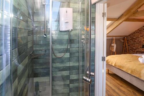 a shower with a glass door in a bedroom at Seagulls Nest in St Ives