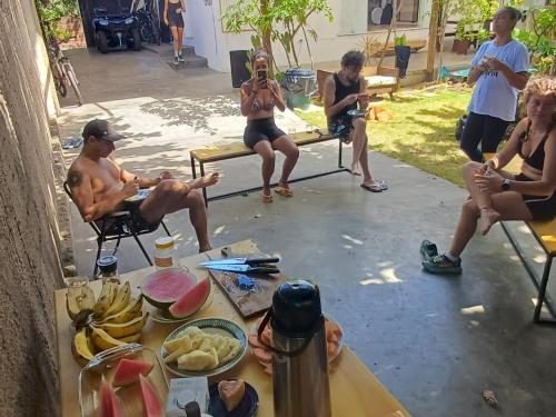 a group of people sitting around a table at Pipa Roots Hostel in Pipa
